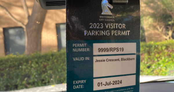 parking permit hanging from inside a car