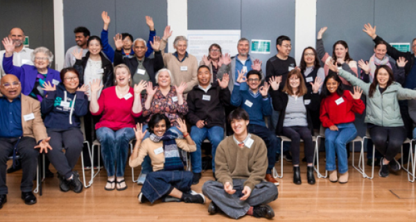 photo of people involved with Shaping Whitehorse forums waving arms and smiling