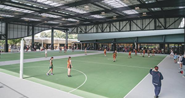 Sportlink stadium showing undercover netball courts with a match