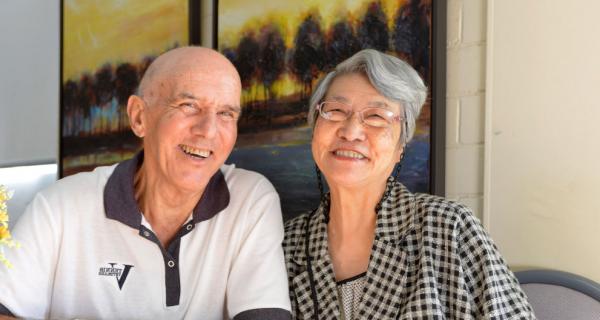 Older lady and man sitting and smiling