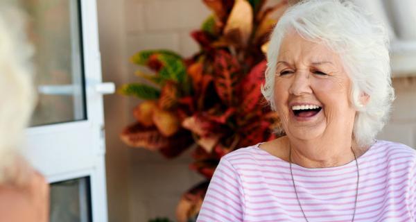 WHACS - Older woman laughing with cup of tea