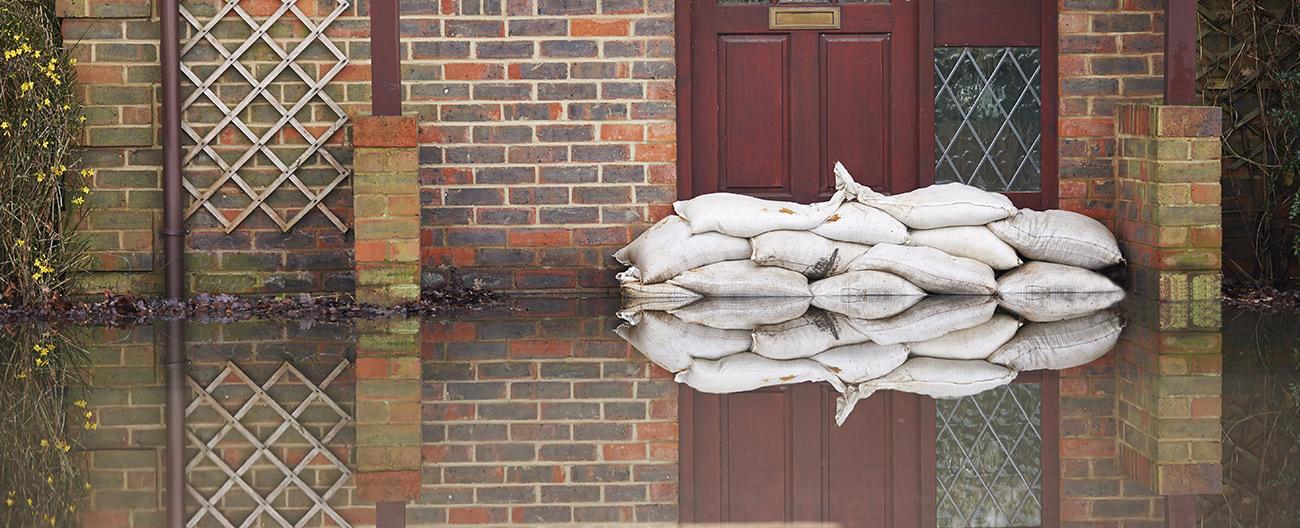 sand bags against a door preventing flood water entering