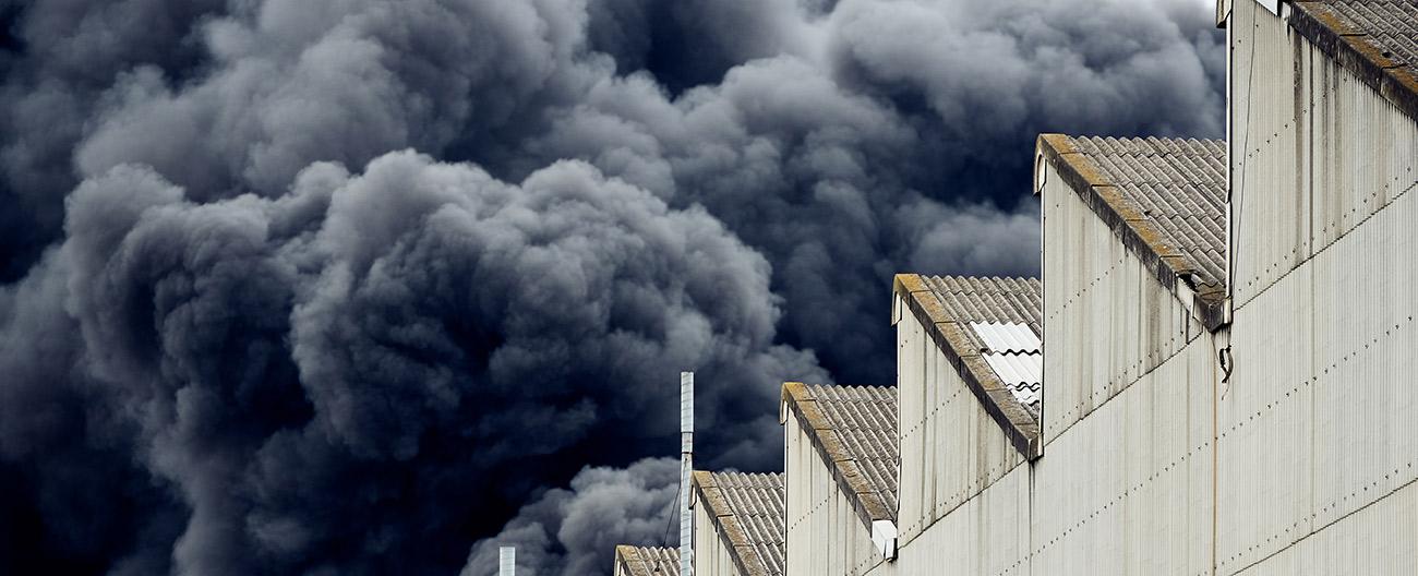 dark smoke raising from a large fire