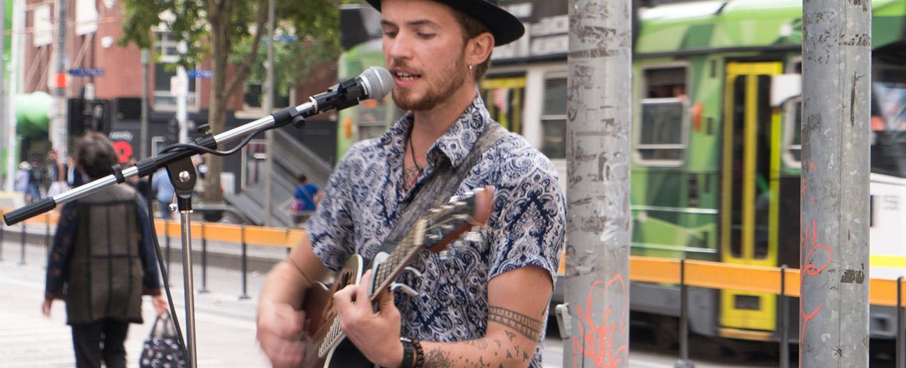 busker playing a guitar