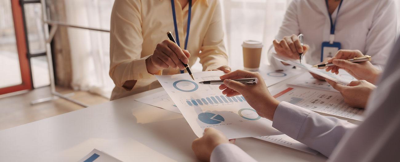 Business people sitting at a table discussing contents of documents