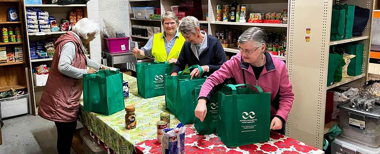 Women packing groceries into bags