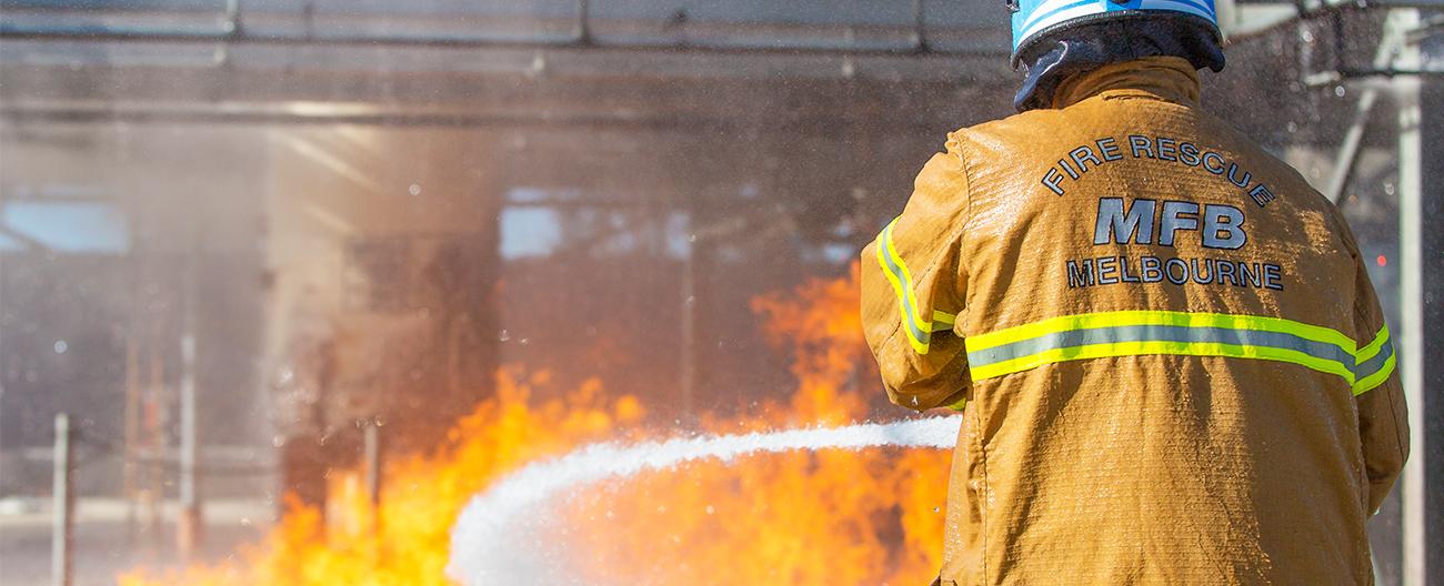 An MFB fire brigade officer fighting fire