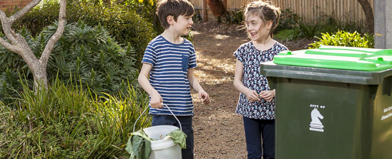 Image of placing waste in garden bin