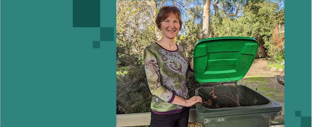 Woman opens green lid of food and garden organics bin 