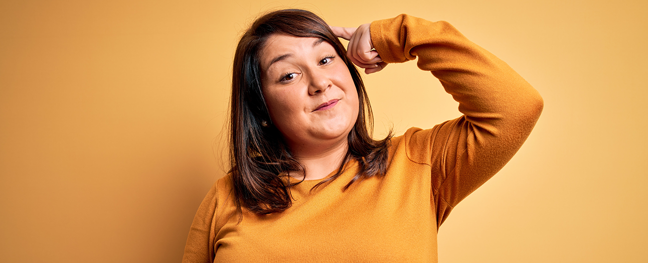 Young woman pointing to her brain