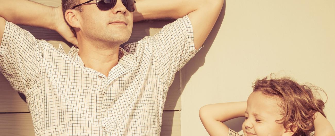 father and son relaxing in the sunshine