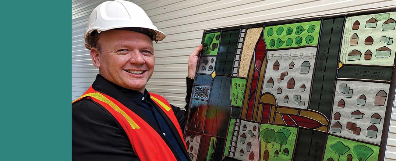 Manager of Arts & Cultural Services looks over a newly repaired section of bicentenary Leadlight