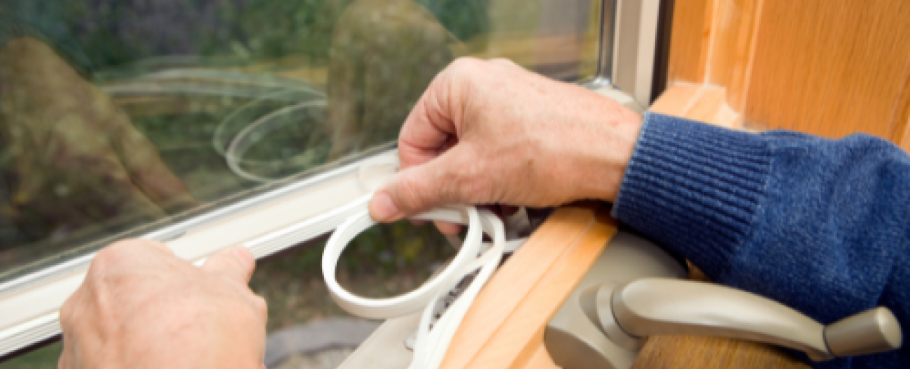 Photo of someone sealing a window
