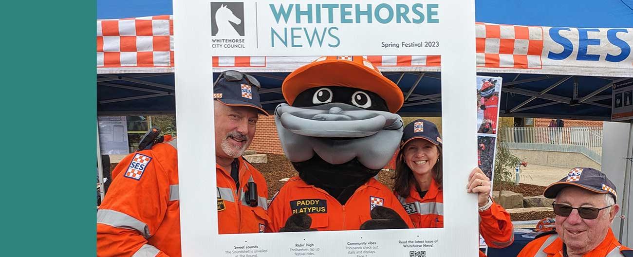 Whitehorse News roving frame with group of SES workers