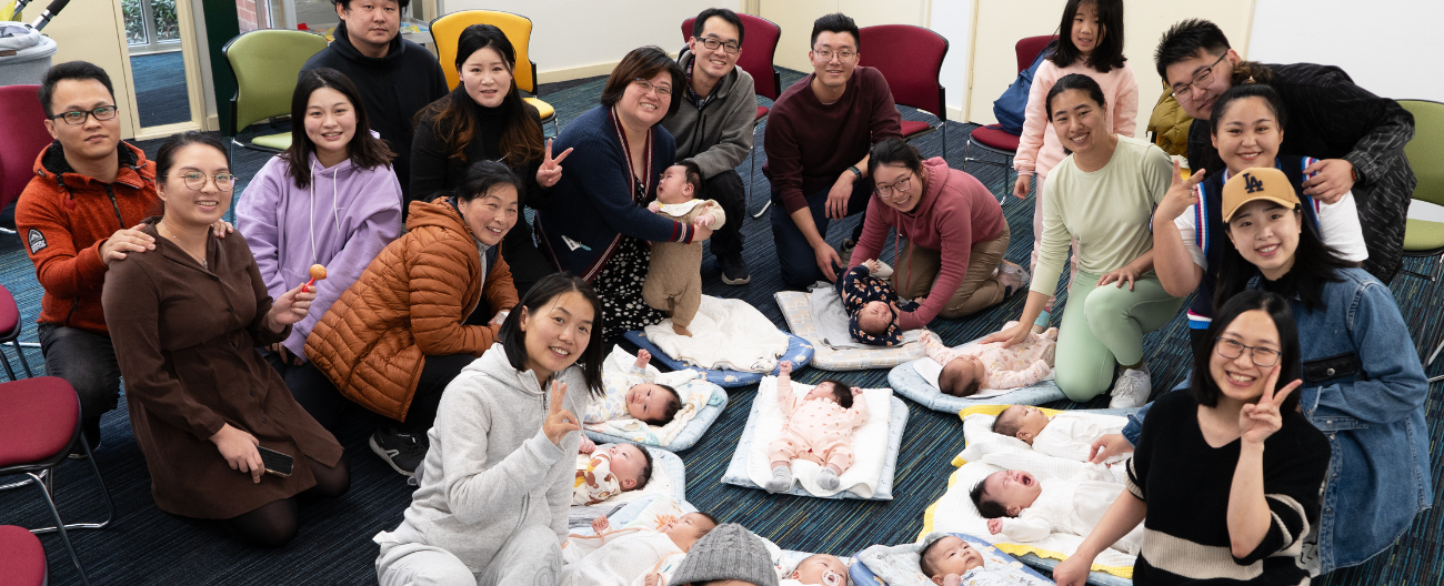 Group of parents with babies lying on the floor