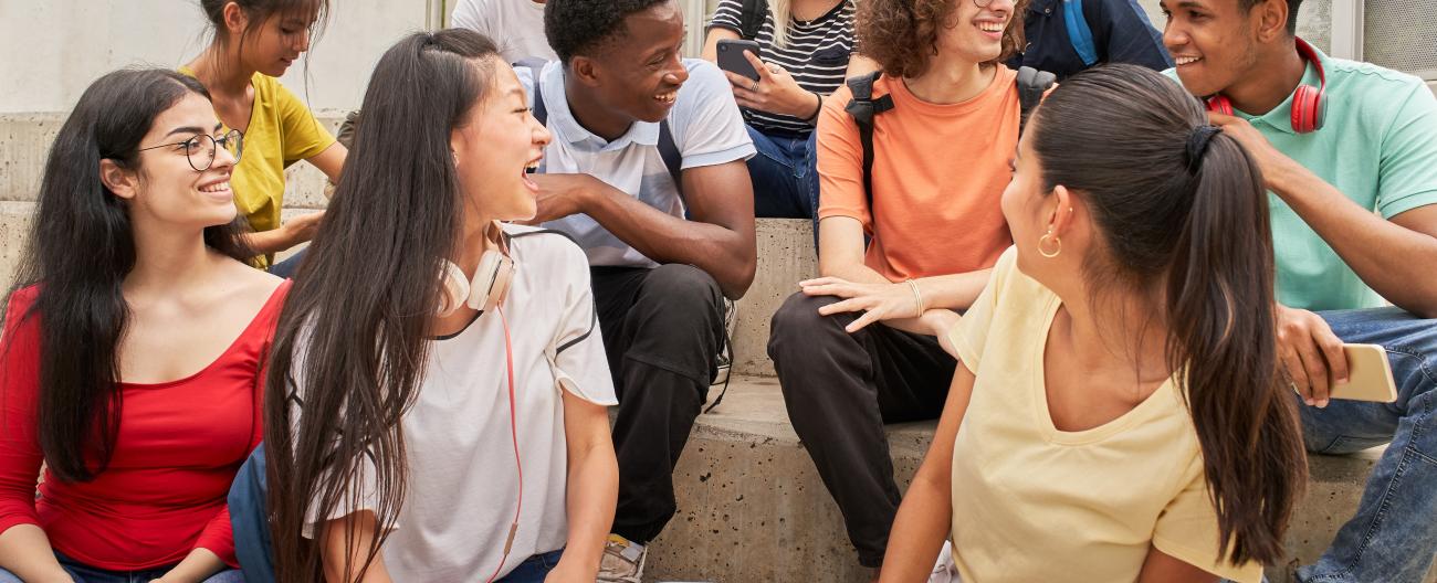 Group of young people sitting on stairs interacting