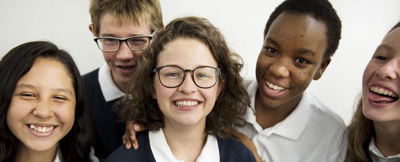 A group of secondary school students laughing