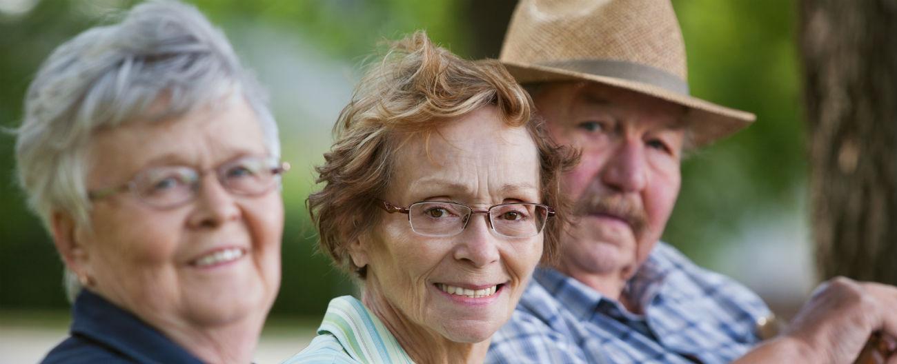 WHACS - Three older people smiling on bench